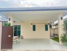 Front view of a modern house with carport and lawn