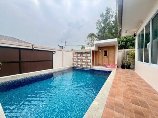 Private swimming pool with patio and lounging area in a residential backyard