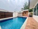 Private swimming pool with patio and lounging area in a residential backyard