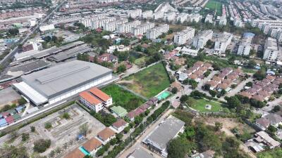 Aerial view of a residential area with a mix of houses, apartments, and industrial buildings