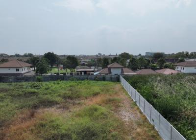 Suburban neighborhood view from an open plot of land