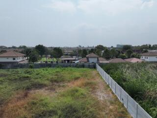 Suburban neighborhood view from an open plot of land