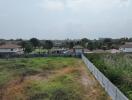 Suburban neighborhood view from an open plot of land