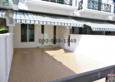 Spacious outdoor terrace with decorative tile flooring and awnings