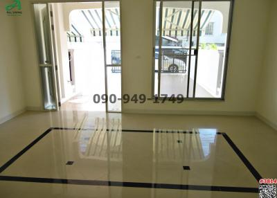 Spacious unfurnished living room with large windows and glossy tiled flooring