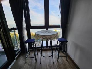 Cozy dining space with a round table and two chairs by the window with a view