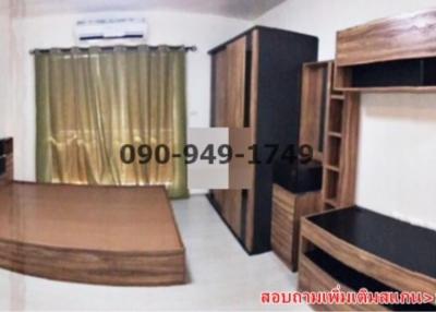 Spacious bedroom with wooden furniture and air conditioning