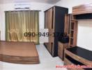 Spacious bedroom with wooden furniture and air conditioning