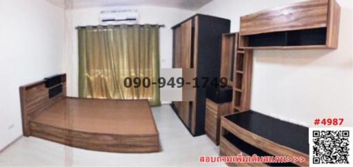 Spacious bedroom with wooden furniture and air conditioning