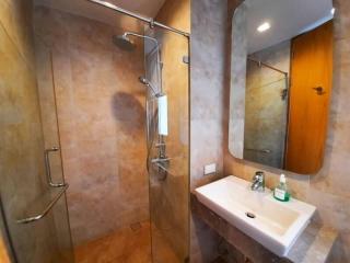 Modern bathroom with walk-in shower and neutral tiles