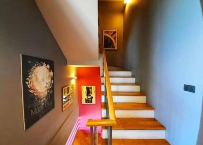 Modern staircase with artistic decor and warm lighting