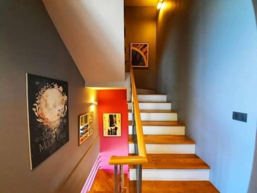 Modern staircase with artistic decor and warm lighting