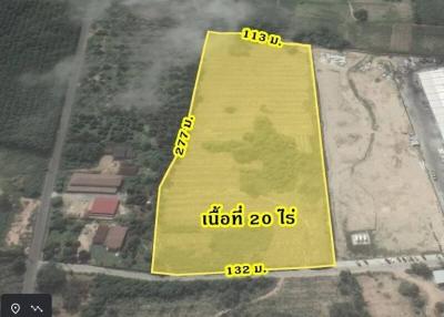 Aerial view of a vacant land plot highlighted for property listing