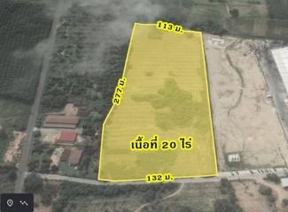 Aerial view of a vacant land plot highlighted for property listing