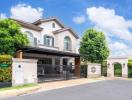 Elegant two-story house with a gated entrance and landscaped front yard