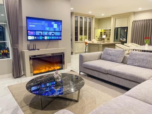 Cozy modern living room with an open kitchen in the background