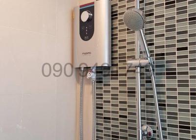 Modern shower with adjustable showerhead and stylish mosaic wall tiles