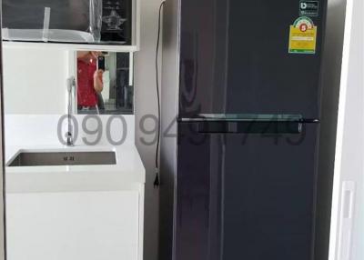 Modern kitchen interior with Samsung refrigerator and white cabinetry