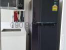Modern kitchen interior with Samsung refrigerator and white cabinetry