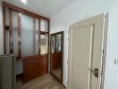 Spacious bedroom with wooden wardrobe and large mirror