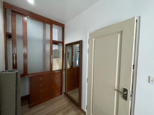 Spacious bedroom with wooden wardrobe and large mirror