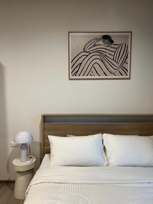 Modern minimalist bedroom with wall art over the bed