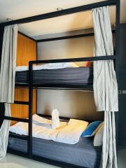 Modern bedroom with double bunk beds and cozy linens