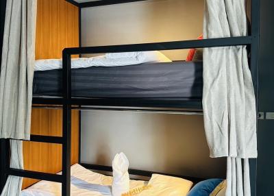Modern bedroom with double bunk beds and cozy linens