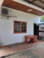 Outdoor covered patio with wooden ceiling and tiled floor