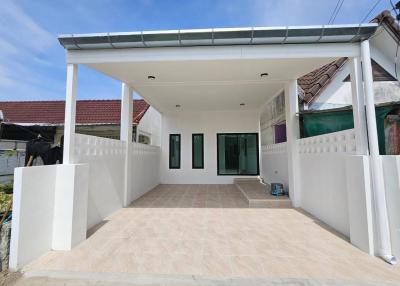 Front view of a modern home with carport and sliding doors