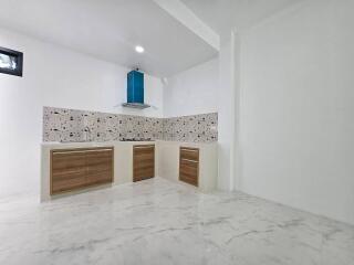 Modern kitchen interior with wooden cabinets and marble flooring