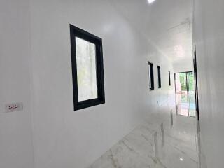 Bright hallway with marble flooring and black framed windows