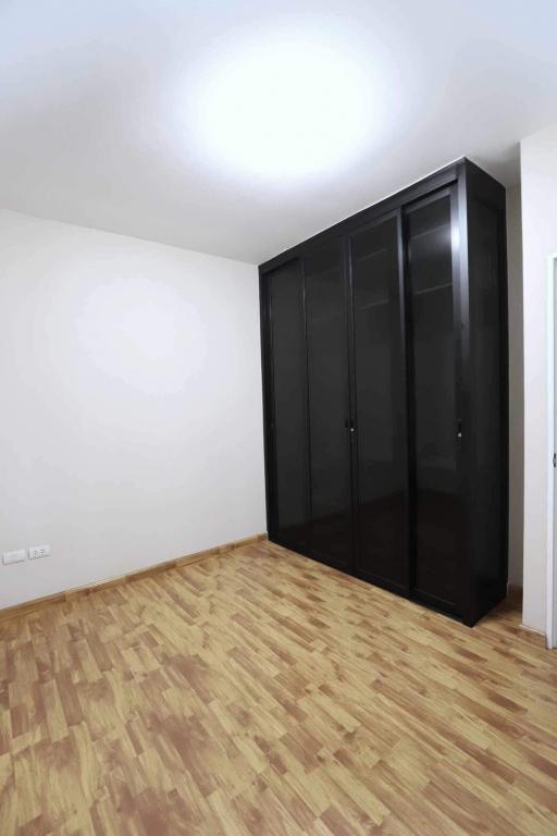 Spacious Bedroom with Large Wardrobe and Parquet Flooring