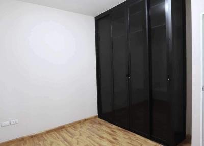 Spacious Bedroom with Large Wardrobe and Parquet Flooring