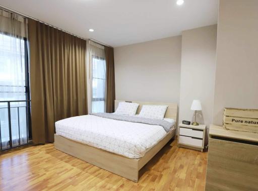 Modern bedroom with natural light and wooden floor