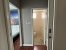 View of a residential hallway leading to a bedroom and bathroom