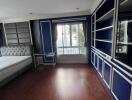 Spacious living room with hardwood floors and French doors leading to a balcony