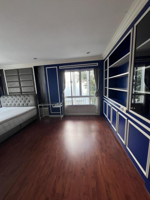 Spacious living room with hardwood floors and French doors leading to a balcony