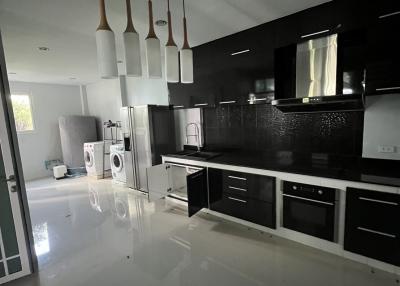 Modern kitchen with black cabinetry and stainless steel appliances