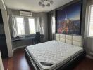 Modern bedroom with a large bed and cityscape wall mural
