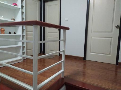 Spacious room with wooden flooring and white doors