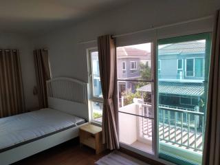 Bright and airy bedroom with a balcony