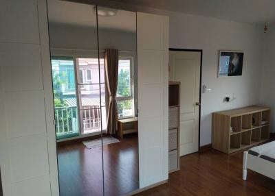 Spacious bedroom with large mirror wardrobe and balcony access