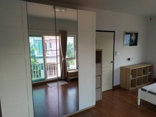 Spacious bedroom with large mirror wardrobe and balcony access