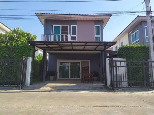 Modern two-story house with carport and gated entrance