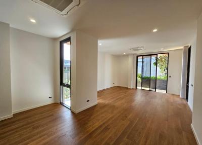 Spacious and modern living room with hardwood floors and ample natural light