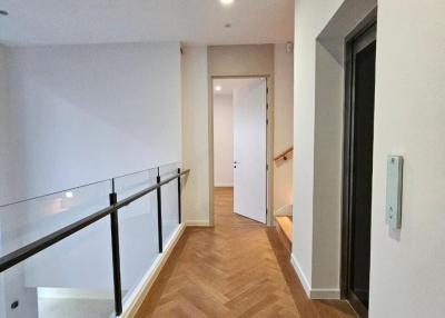 Spacious corridor inside a modern home with wooden flooring