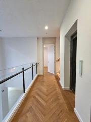 Spacious corridor inside a modern home with wooden flooring