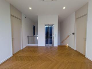 Spacious and well-lit empty room with wooden flooring