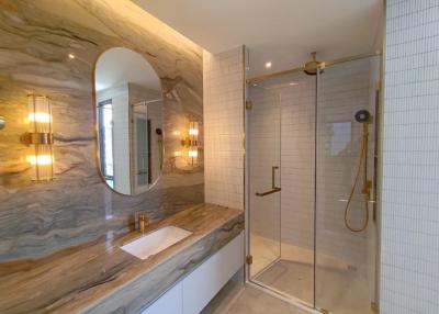 Modern bathroom with glass shower and unique marble sink
